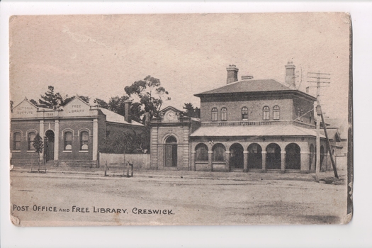 Postcard of town  buildings and street