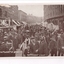 Building lined street contains a mass of people