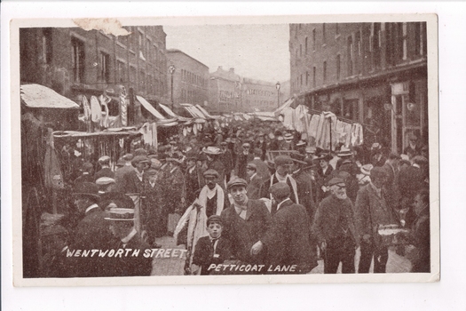 Building lined street contains a mass of people