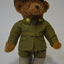 Brown teddy bear, wearing WW1 Lance Corporal Army uniform with rising sun badges on collar, slouch hat and 59th Battalion patch on right shoulder.
