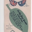 Postcard with rising sun and two flags above attached cutout in the shape of a gum leaf.