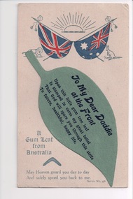 Postcard with rising sun and two flags above attached cutout in the shape of a gum leaf.