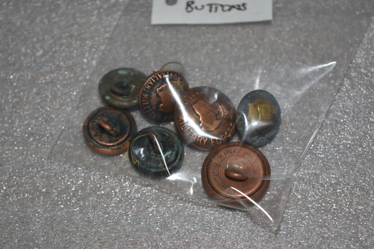 Large and small brass colour buttons with  a map of Australia in the middle with a crown on top.