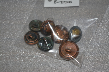 Large and small brass colour buttons with  a map of Australia in the middle with a crown on top.