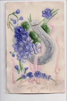 Plastic postcard showing purple flowers and lucky horseshoe with paper backing 