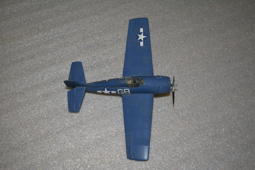 Small blue model aircraft with one star on wing 