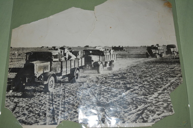 Black and white photograph of Italian lorries in convoy in the desert