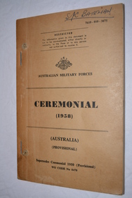 Light Brown paperback  book with black writing with Australia crest.