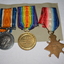 Two round and one star shaped medals with ribbons attached 