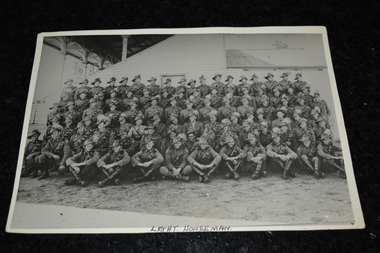 Black and white unframed photograph of large troop of Light Horse soldiers taken at side of a grandstand.