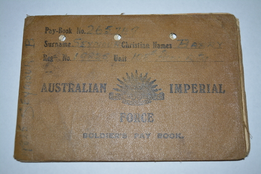 Brown canvas booklet with rising sun emblem and writing in black ink.