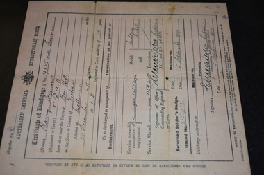 Pale pink coloured paper document with black writing and crest.