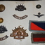 Mounted on white cardboard 7 badges, two patches and two buttons