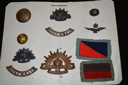 Mounted on white cardboard 7 badges, two patches and two buttons
