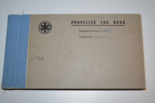 Grey cardboard book with spine bound in blue fabric