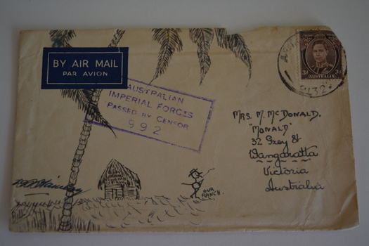 Hand drawn picture of stick figure and hut under palm tree on stamped addressed envelope 