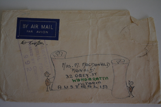 Cream paper envelope with hand drawn scroll with stick figure either side 