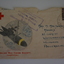 Stamped addressed envelope with coloured hand drawn picture of figure sitting on top of a missile