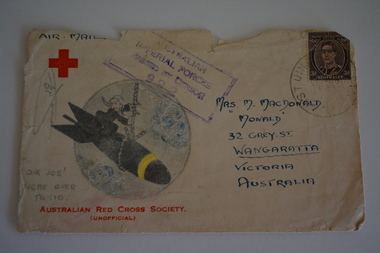 Stamped addressed envelope with coloured hand drawn picture of figure sitting on top of a missile