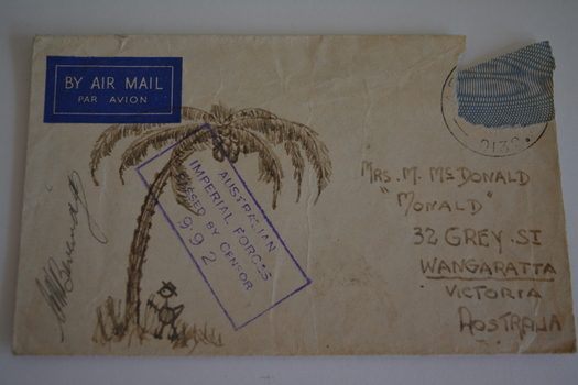 Cream paper envelope with brown coloured sketch of palm tree with stick figure at base.  Signature left of sketch