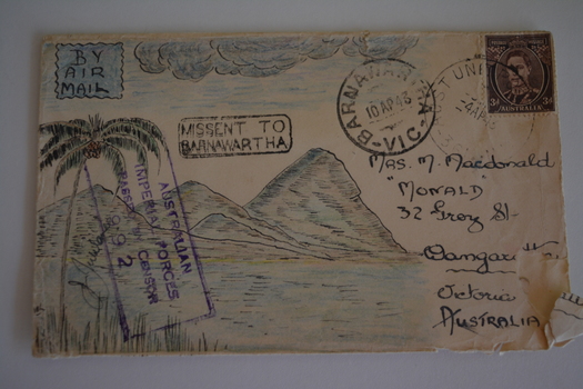 Cream paper envelope with coloured sketch of palm tree and mountains and cloudy sky.