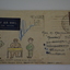 Cream paper envelope with coloured sketch of yacht sailing at sunset.