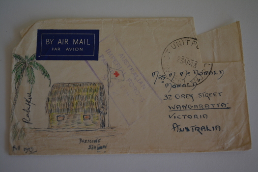 Cream paper envelope with coloured sketch of flag pole with two flags next to thatched hut and ambulance