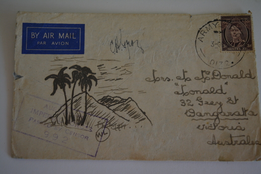 Cream paper envelope with sketch of three tall palm trees in front of mountains