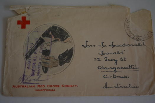 Cream paper envelope with a circular sketch of an eagle holding shell/bomb 