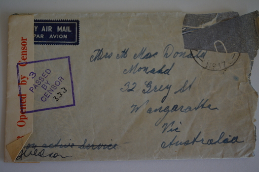 Cream paper envelope with handwritten address, censor stamp and sticker. 