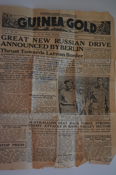 Two page cream coloured newspaper with black print and photograph.