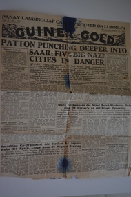 Two page cream coloured newspaper with black print and photograph.