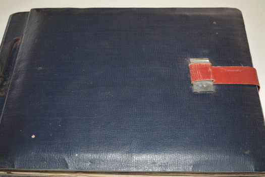 Dark Blue leather bound album with red leather strap and silver plastic clasp
