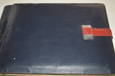 Dark Blue leather bound album with red leather strap and silver plastic clasp