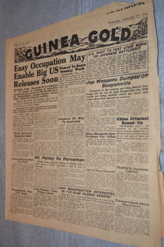 Two page cream coloured newspaper with black print and photograph.