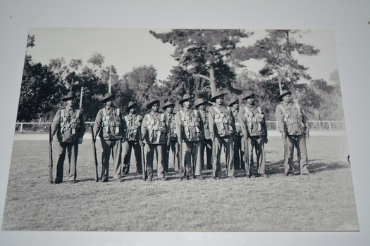 Black and white photograph of platoon of soldiers at ease on parade