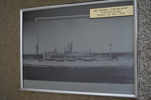 Black and white photograph of large ship with lifeboats at sea