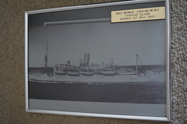Black and white photograph of large ship with lifeboats at sea