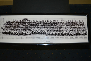 Framed black and white photocopy of large company of soldiers in five rows