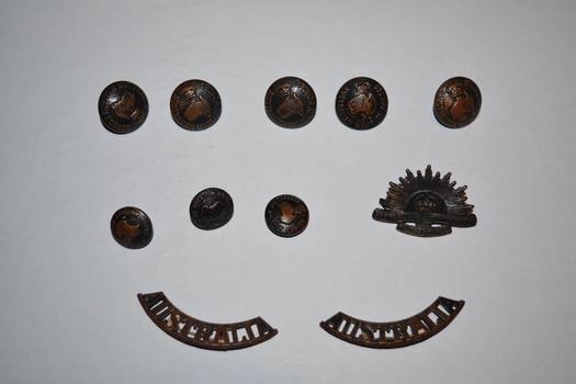 brass military buttons and badges