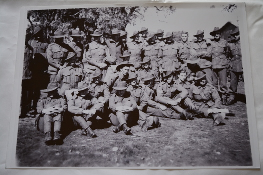 Large group of soldiers wearing slouch hats standing  and sitting 