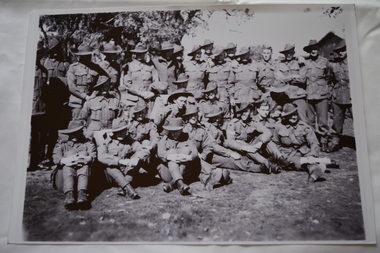 Large group of soldiers wearing slouch hats standing  and sitting 