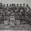 Reproduced black and white photograph of band of soldiers with musical instruments in the field