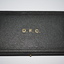 Black case which opens out from right side.  The top affixed by two side hinges on the left and push in pin on the right side.   