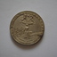 Circular silver metal medal- obverse side has coat of arms above image of woman in a field - rear side embossed with laurel wreath.