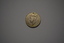Round shaped silver metal medal  depicting a head with crown and on the reverse side a lion.