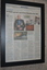 Black frame containing newspaper article of obituary with three images
