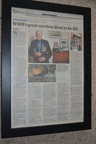 Black frame containing newspaper article of obituary with three images