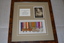 Brown frame containing beige mount housing photograph and six medals attached to striped ribbons