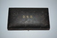 Small rectangular black leather look covered timber box with DSO stamped on lid.